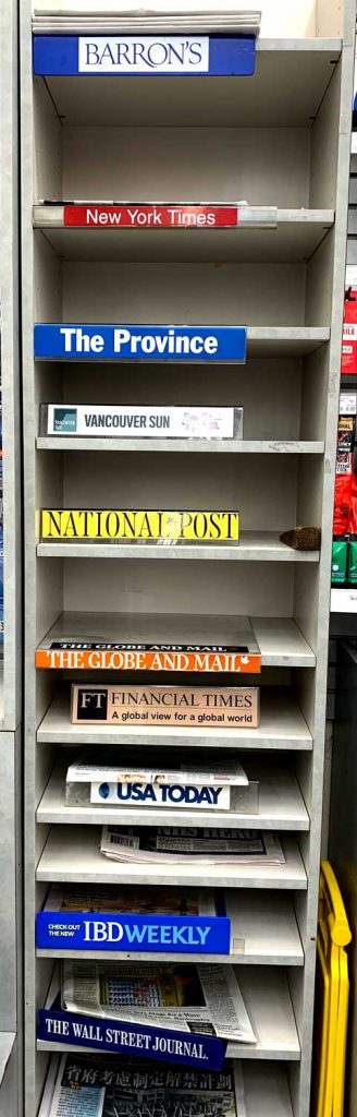 Empty cubbies with news organization labels